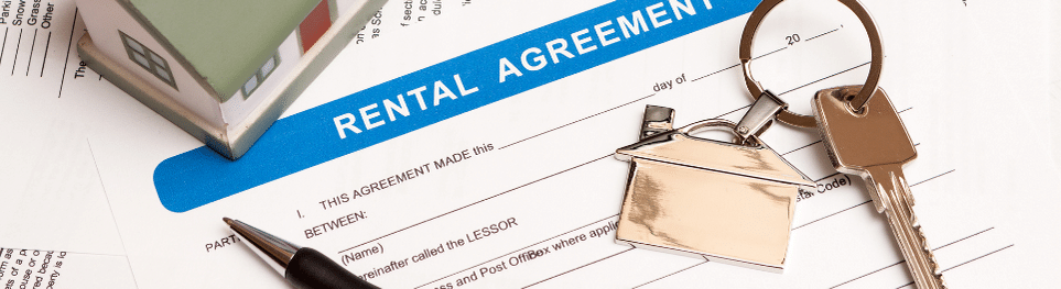 a house figure and key and the contract